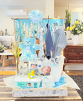 Baby shower gift hamper with baby clothes, plush toys, and assorted baby care items