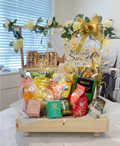 Housewarming gift hamper with gourmet treats, luxurious teas, and charming home decor items